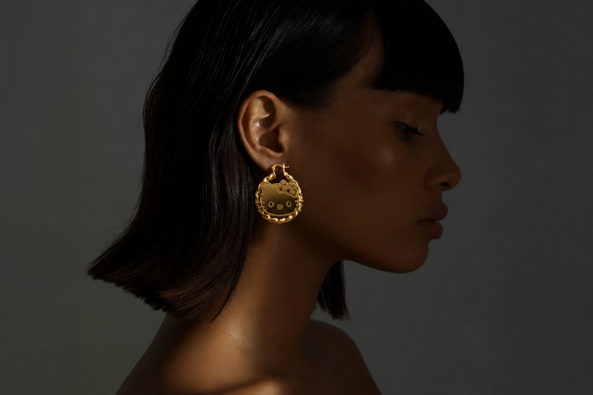 Model wearing the gold Hello Kitty hoop earring